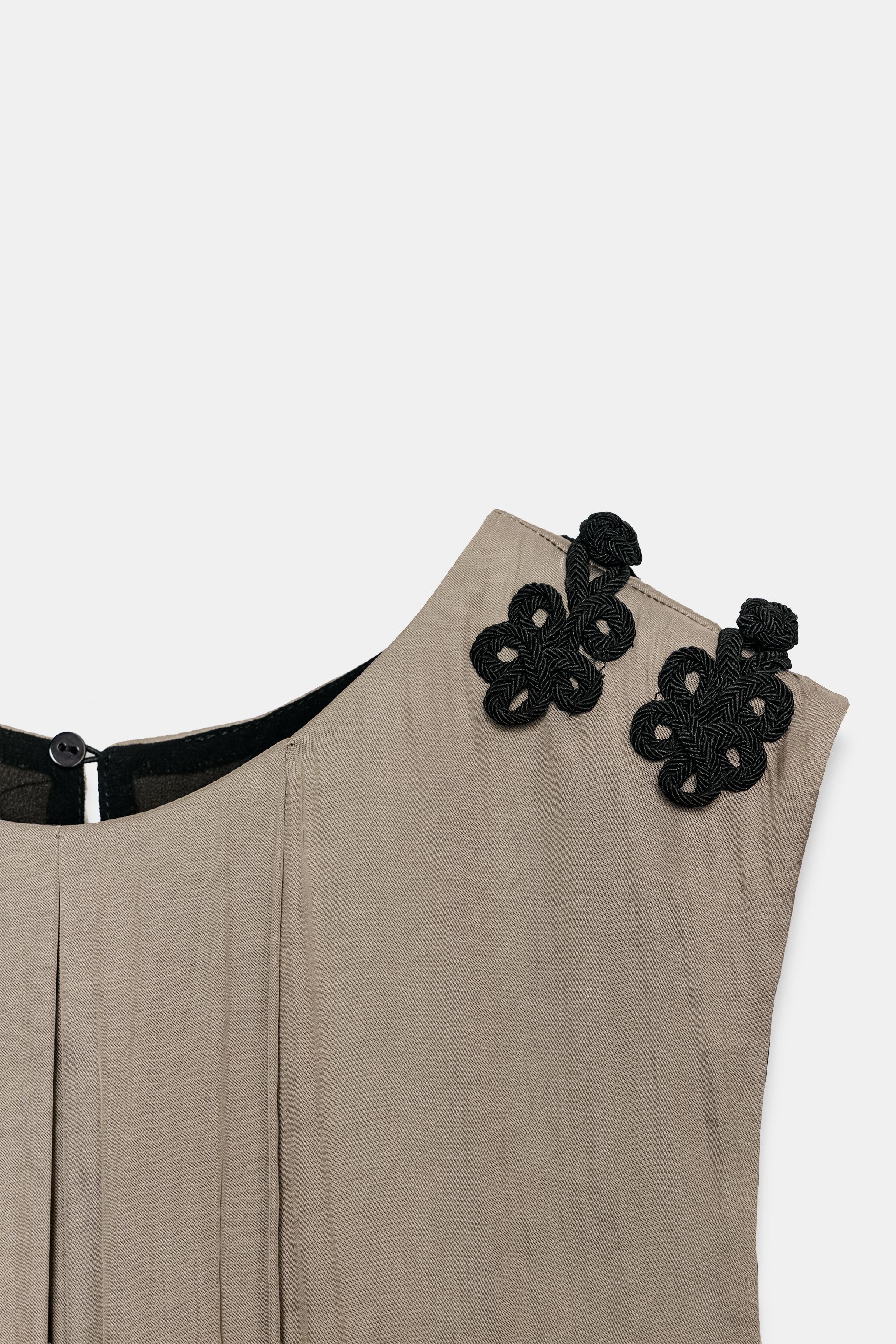 SATIN JUMPSUIT WITH SHOULDER FROG FASTENING